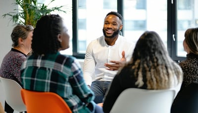 Business leader engaging with team during a conscious leadership coaching session Business leader engaging with team during a conscious leadership coaching session